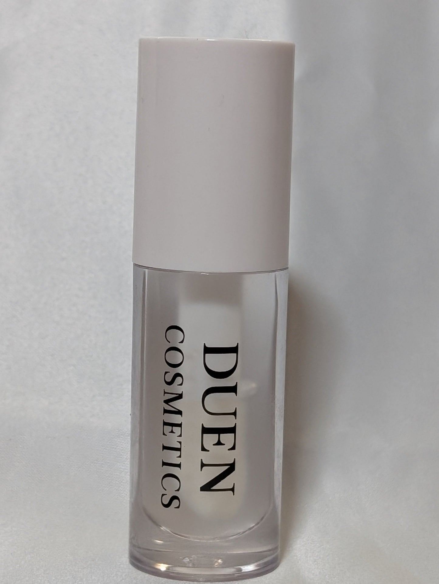 Cosmetic bottle with 'Duen Cosmetics' clear unscented Lipgloss 